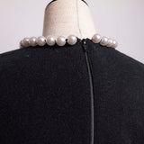 Pull avec collier de perles